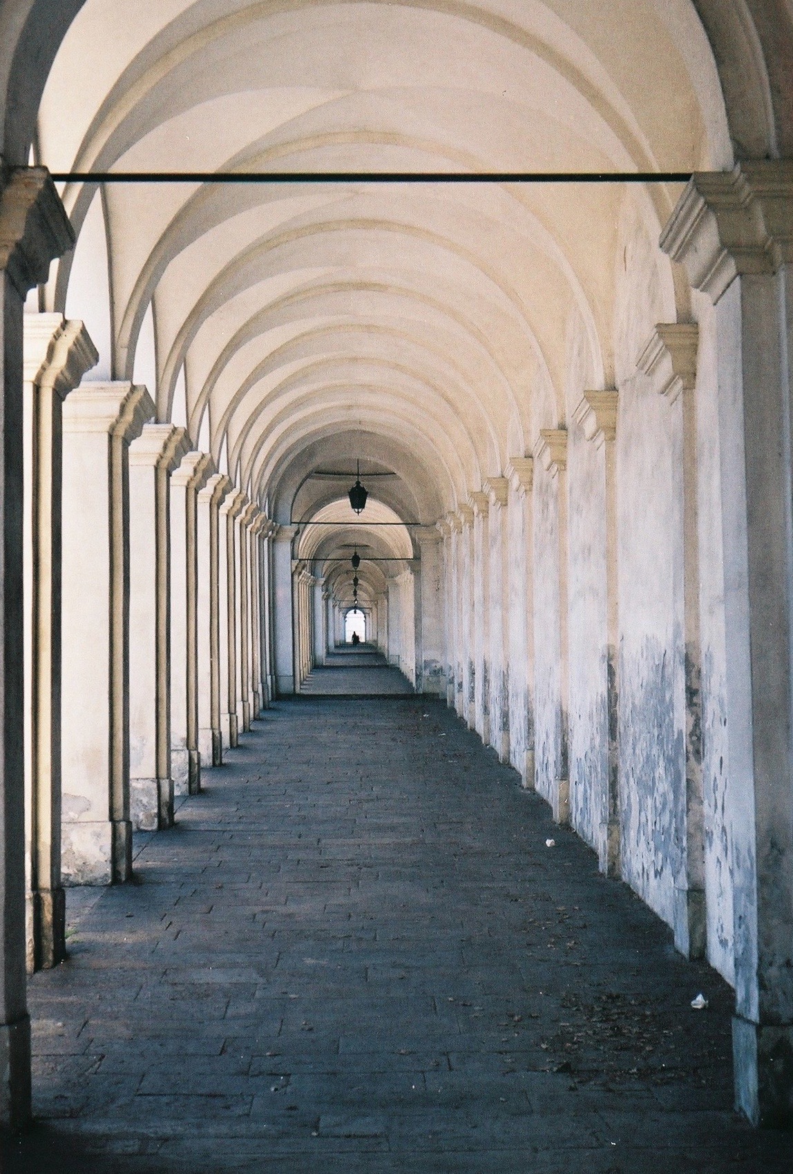 Arched colonnade receding into light